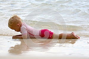 Baby lying on the beach