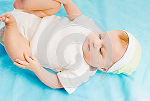 Baby lying on a blue plaid