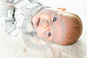 Baby lying child banner. Happy cute baby infant girl lying on white bed background. Cute small boy lying at bed