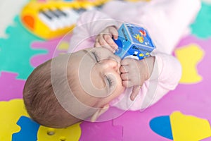 Baby lying on child friendly floor puzzle