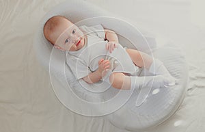 The baby is lying in a cocoon of copy space . The baby is 0-3 months old. A contented infant. An article about choosing