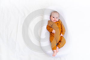 The baby is lying in a cocoon of copy space . The baby is 0-3 months old. A contented infant. An article about choosing