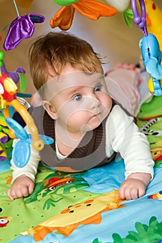 Baby Lying on Colorful Mat