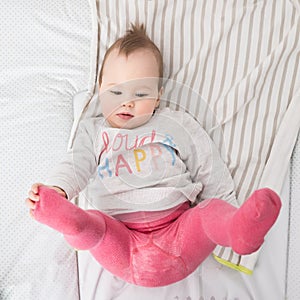 Baby lying on the desk during chaning of clothes