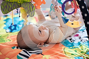 Baby lying on Developing rug.