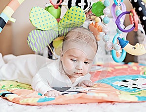 Baby lying on Developing rug.