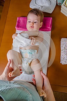 Baby lying playing with a small towel