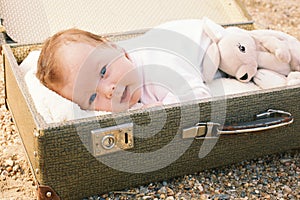 Baby lying in a suitcase