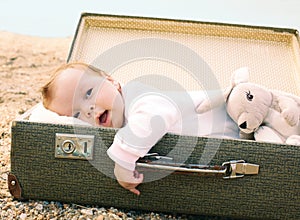 Baby lying in a suitcase