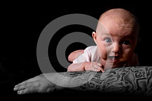 Baby Lying on Tattooed Arm