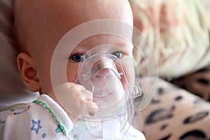 Baby in mask for inhalation