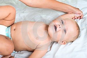 Baby massage. Mother massaging infant belly