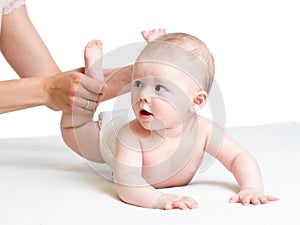 Baby massage. Mother massaging kids legs