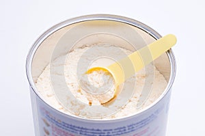 Baby milk powder in cans that open with a spoon