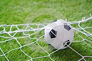 Baby mini football background with a football goal and soccer ball on the soft artificial grass