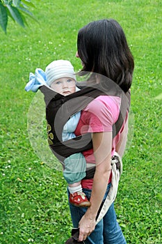 Baby with mom in baby carrier