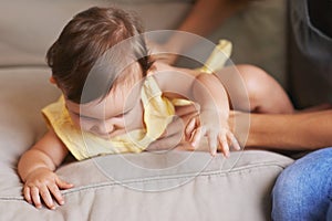 Baby, mom and playing on couch, child development and infant growth with happy, coordination and home. Girl, learning