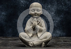 Baby monk praying statuette