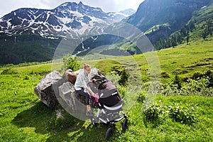 Baby and mother with the Alps mountains in nature in the Backgro