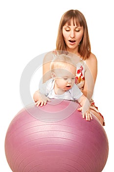 Baby with mother on fitness ball