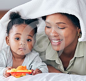 Baby, mother and love under a bedroom blanket on a bed with happiness of black woman. Relax, parent support and care