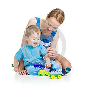 Baby and mother playing together with set toy