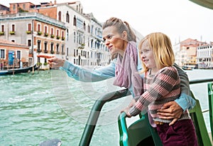 Baby and mother travel by vaporetto in venice photo