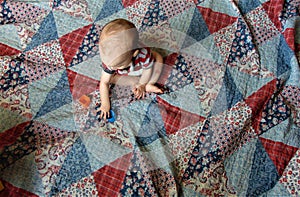 Baby on Multicolored Patchwork Quilt