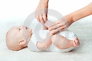 Baby with mum is making massage