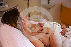 Baby in new mother& x27;s hands after giving birth