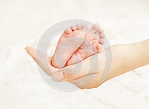 Baby Newborn Feet Mother Hands. New Born Kid Foot, Family Love