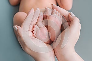 Baby Newborn Feet Mother Hands. New Born Kid Foot, Maternity