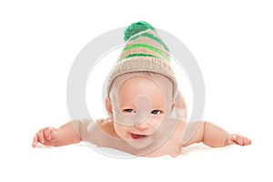 Baby newborn lying on her stomach on the bed in a funny knitted hat isolated on white background, the concept of choosing baby clo