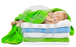 Baby newborn sleeping wrapped in bath towels