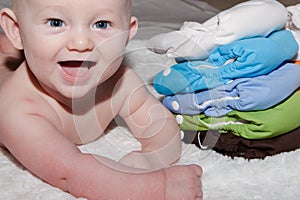 Baby Next to a Stack of Cloth Diapers