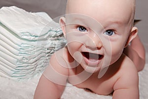 Baby Next to Stack of Disposable Diapers