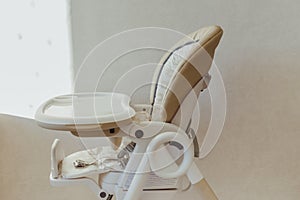 Baby nibbler on high chair in interior photo