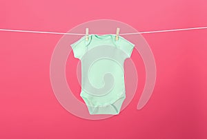 Baby onesie hanging on clothes line