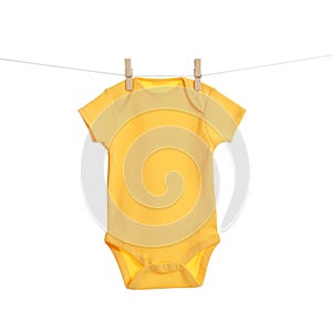 Baby onesie hanging on clothes line. Laundry day