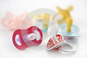 Baby pacifier set over white background
