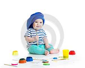 Baby with paintbrush and paints