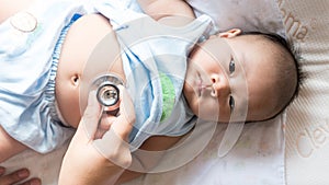 Baby patient have check fever with stethoscope in hospital