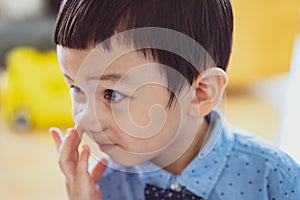 Baby picking nose. little baby boy with finger in his nose. Cute little baby boy picking his nose, close up.