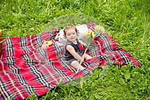 Baby on picnic, plaing with sunflower