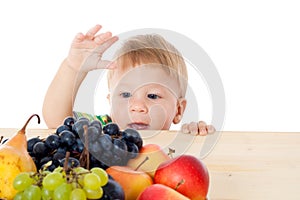 Baby with pile of fruit