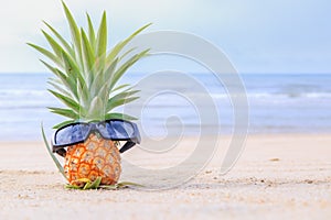 Baby pineapple wearing glasses on the Huahin beach