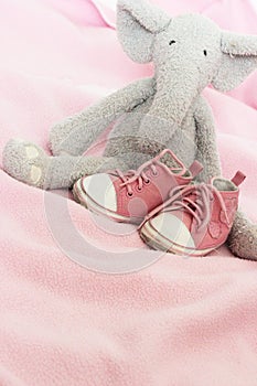 Baby pink shoes and plush elephant photo