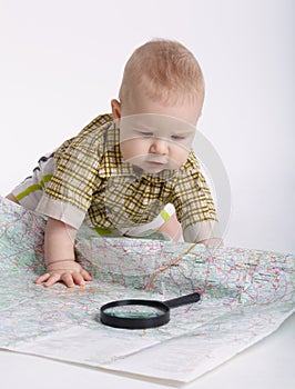 Baby planning travel with map on white