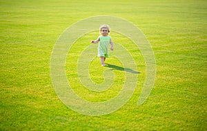 Baby play in green grass. Child development. Adorable little kid walking in an autumn field.