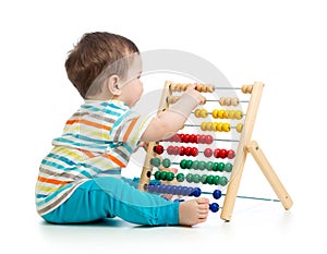 Baby playing with abacus. Isolated on white background